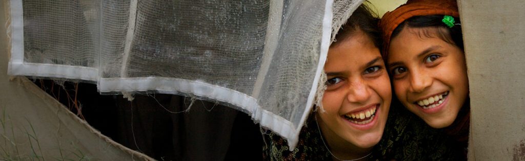 two young girls smiling and laughing.