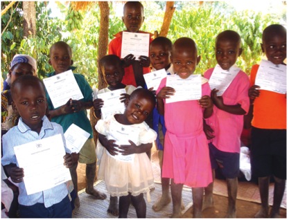 Ugandan children proudly show off their birth certificates.