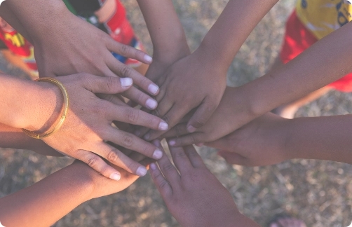 Childrens hands in a circle.