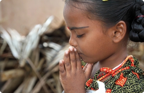 a young girl praying.