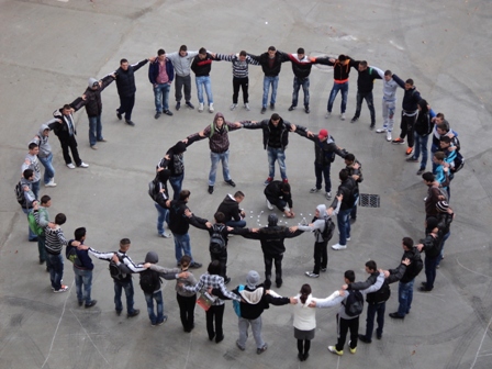 World Day Observance in Bistrita and Lasi, Romania kids forming a circle as seen from above.