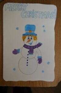 World Day Observance in Bistrita and Lasi, Romania poster of a snowman by a child.