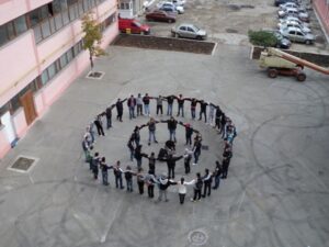World Day Observance in Bistrita and Lasi, Romania kids forming a circle as seen from above.